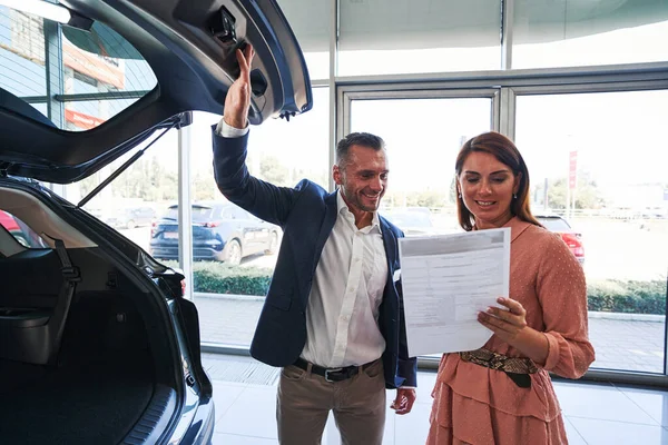 Happy couple reading the contract before signing it — Stock Photo, Image