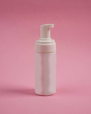Pompalı sabun şişeleri pembe arka planda izole edilmiş. Farklı kapaklı kozmetik plastik şişe (sprey, sprey pompa). Jöle, losyon, krem, şampuan, banyo köpüğü için sıvı kap..