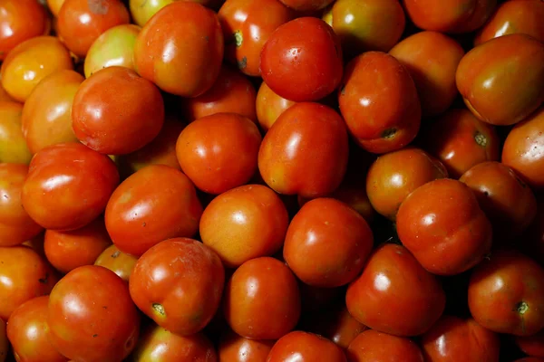 Delicious red tomatoes it can be used as background. (selective focus). Tomato vegetable concept space for banner top view. Tomatoes for background. Healthy eyes with regular consumption of tomatoes.