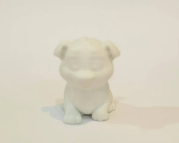 Dog shaped cnc router. 3D design made of plastic. Miniature animals are suitable to be used as collections or room furniture. Laser cutting. Laser templates. Focus blur.