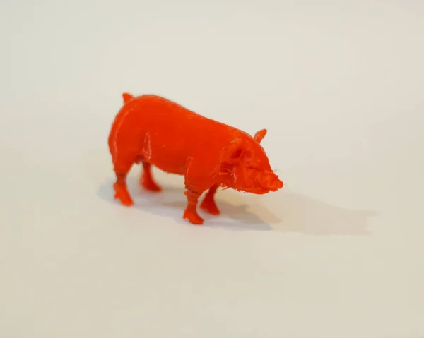 The cnc router is in the shape of a pig. 3D design made of plastic. Miniature animals are suitable to be used as collections or room furniture. Laser cutting. Laser templates. Focus blur.