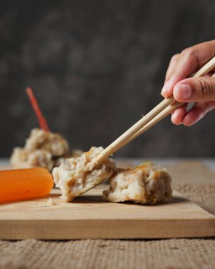 Siomay koyu bir arka planda soluk soluğa olabilir. Siomay 'ın İç Moğolistan' dan geldiği düşünülüyor. Çince, siomay (shaoma). Endonezya hamur köfteleri genellikle ana malzeme olarak uskumru kullanır. Odak bulanıklığı.