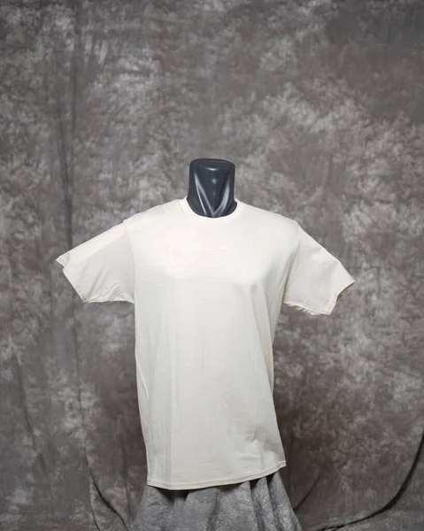 Cream color men\'s blank t-shirt template, front view, natural shape on invisible mannequin, for your design mockup for printing, isolated on gray motif background. Free space for your ad.