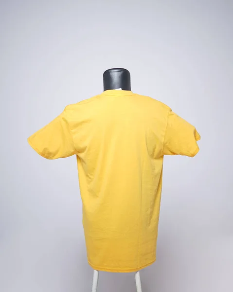 Yellow blank men's t-shirt template, back view, natural shape on invisible black mannequin, for your mockup design to print, isolated on plain white background. Free space for your ad.