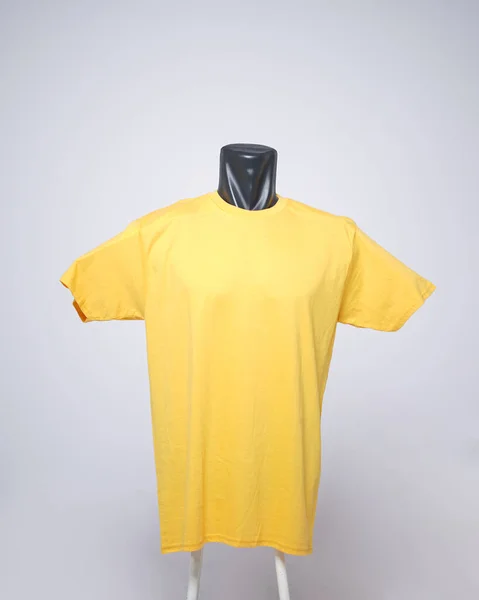 Yellow blank men's t-shirt template, front view, natural shape on invisible black mannequin, for your mockup design to print, isolated on plain white background. Free space for your ad.