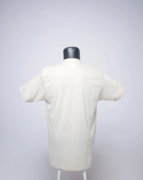 Cream color men\'s blank t-shirt template, back view, natural shape on an invisible mannequin, for your mockup design to print, isolated on a plain white background. Free space for your ad.