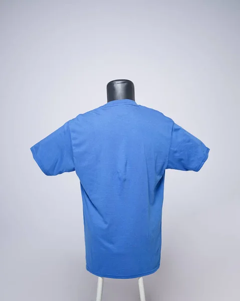 Dark blue men's blank t-shirt template, back view, natural shape on an invisible mannequin, for your mockup design to print, isolated on a plain white background. Free space for your ad.