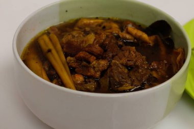 Rawon ineği beyaz arka planda izole edilmiş. Rawon, Endonezya usulü, özel baharat karışımı kluwek kullanan bir kara et çorbası türüdür. Rawon 'un eti genellikle sığır etidir. yemek modeli.
