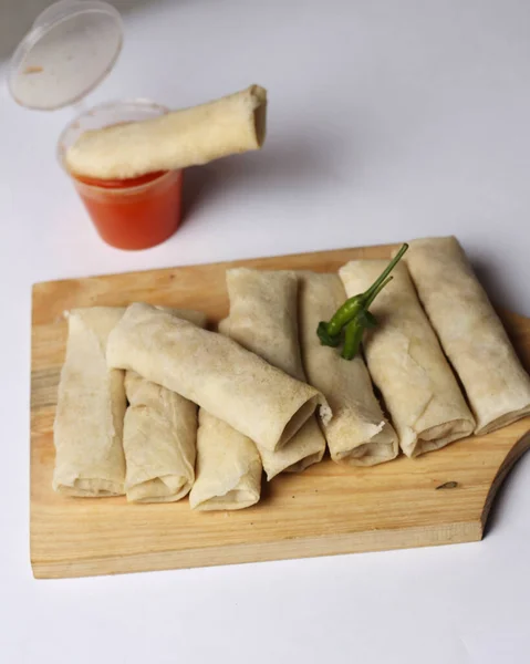 Lumpia is a typical Semarang cake. The spring roll cake is not fried, so the texture is soft. Blurred focus. Spring rolls consist of a thin sheet of wheat flour as a wrapper for the filling of eggs.