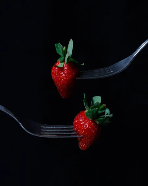 Fresh strawberries isolated on dark background. In addition to its delicious taste, strawberries also have benefits for the body, such as increasing immunity and preventing cancer. Strawberry mockup.