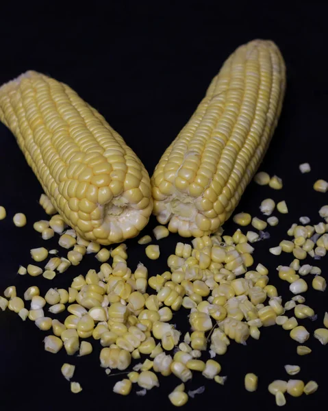 Sweet corn isolated on dark background. This corn can be served in various processed forms. Whether it\'s boiled, baked, or mixed with other foods to serve as a side dish or snack. Corn mockup.