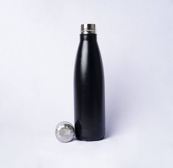 The contrast between the black bottle and the white background creates a striking minimalist look                               