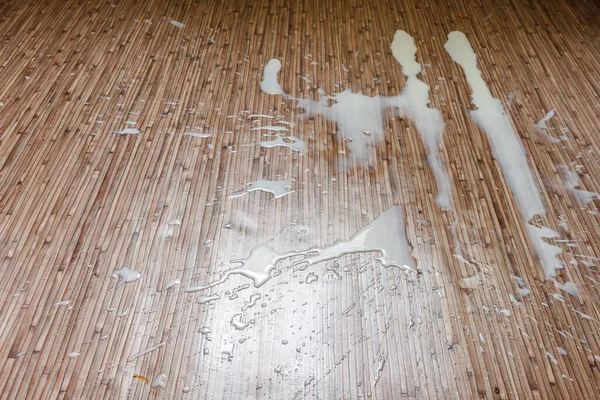 Spilled milk on the kitchen floor. Top view