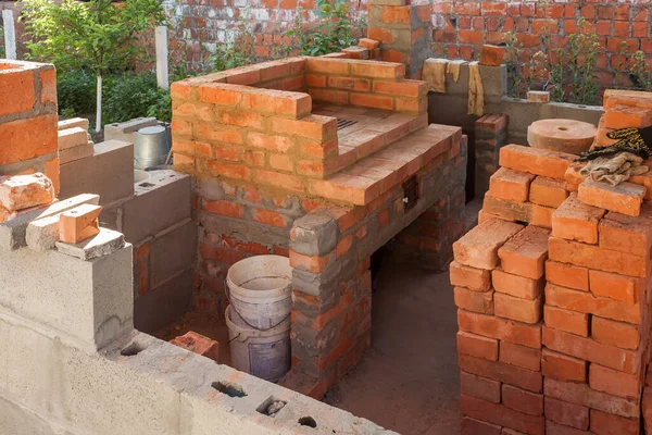 Construction of a brick fireplace in a gazebo.