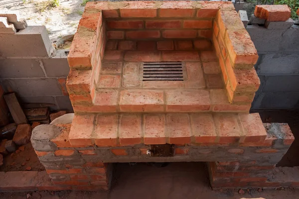 Construction of a brick fireplace in a gazebo.