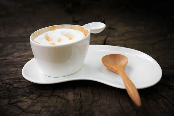 Cup of coffee with wood spoon — Stock Photo, Image