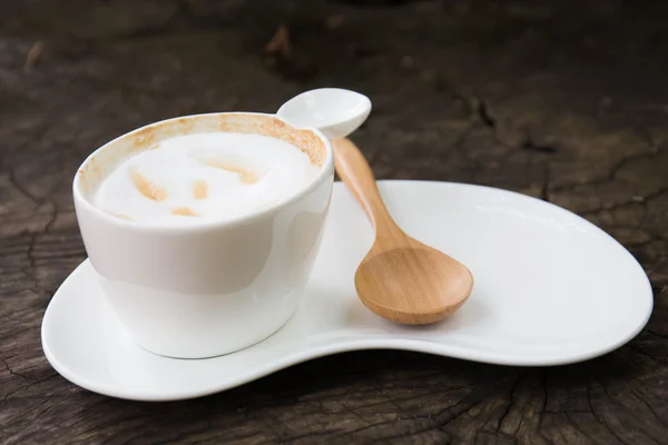 Cup of coffee with wood spoon — Stock Photo, Image