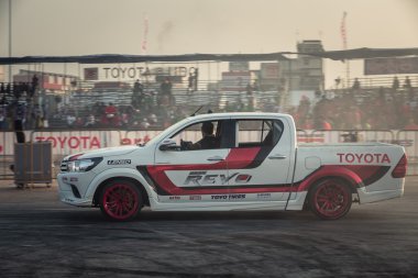 driver waving hand to the audience after show with motion blur