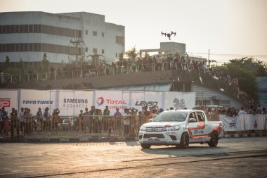 broadcasting drone above the car