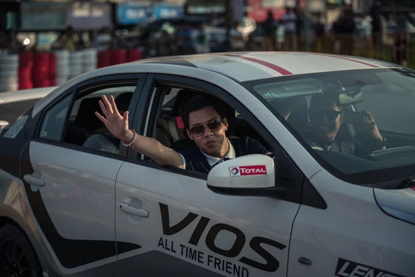 driver waving after car performance show