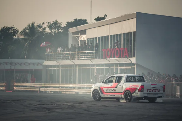 Pick-up car perform burnout tire on the track