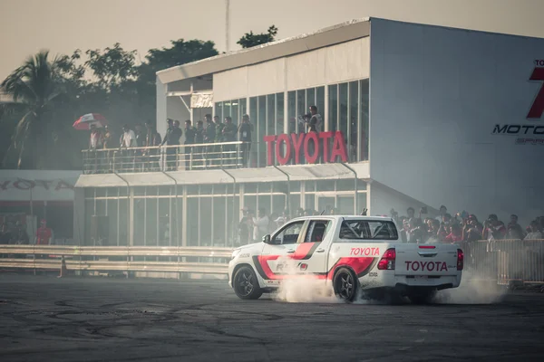 Pick-up car perform burnout tire on the track