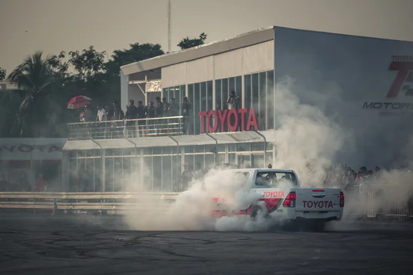 Pick-up car perform burnout tire on the track