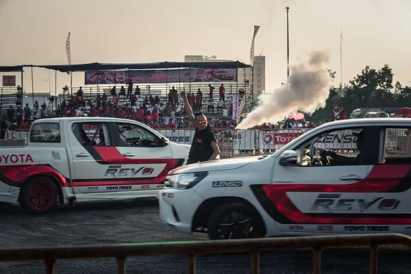 cars drifting show between master of ceremonies in the center