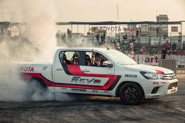 Pick-up car perform burnout tire on the track