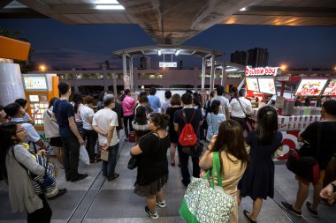 crowd of people in rush hour at BTS public train station at night