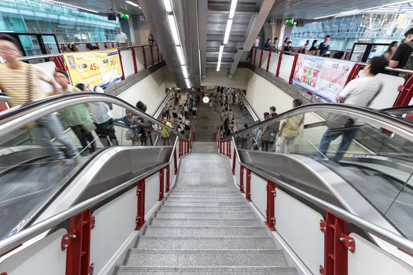 people at BTS public train station using escalator