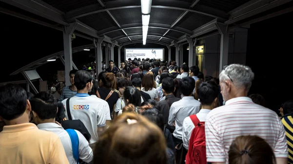crowd of people in rush hour at BTS public train station at night