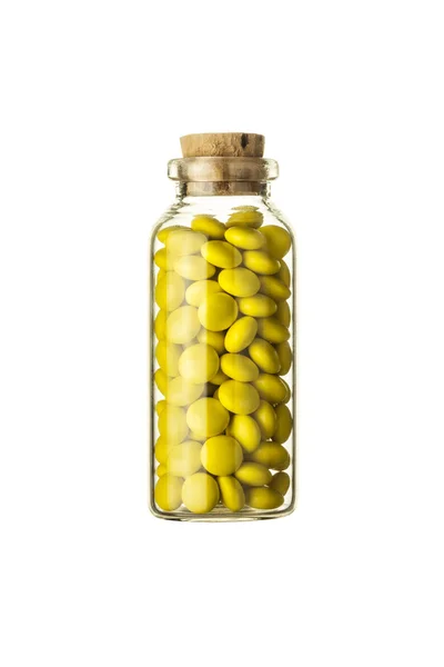 Флакон полный маленьких желтых таблеток Лицензионные Стоковые Фото