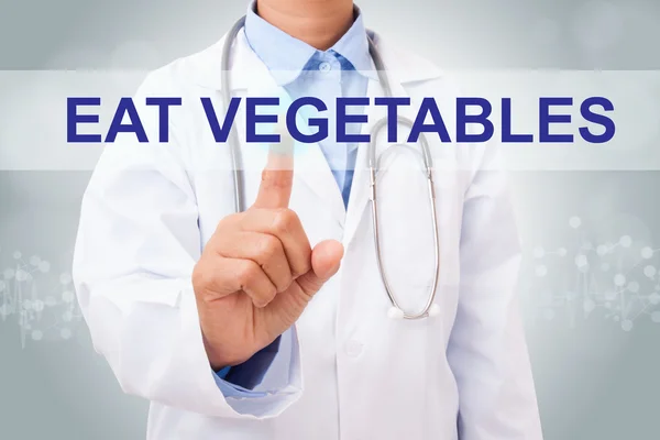 Médecin avec manger des légumes signe — Photo
