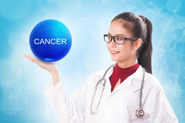 Female doctor holding blue crystal ball with cancer sign on medical background. — Stock Photo, Image