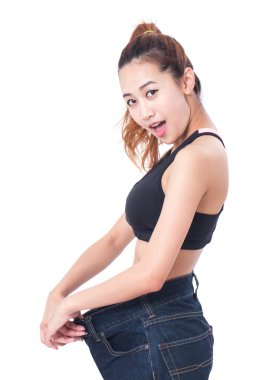 Beyaz arka plan üzerinde işaret parmağı çok büyük kot giyen genç ince kadın