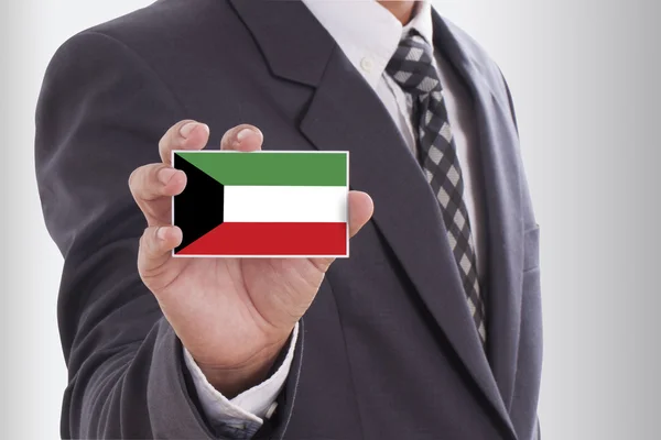 Businessman in suit holding Kuwait Flag — Stock Photo, Image