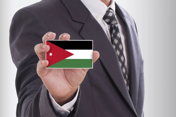 Businessman in suit holding Jordan Flag — Stock Photo, Image