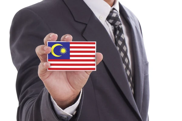 Affärsman i kostym holding Malaysia flagga — Stockfoto