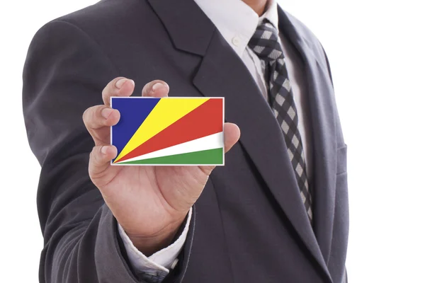 Affärsman holding Seychellernas flagga — Stockfoto