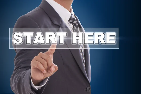 Businessman hand touching start here on screen — Stock Photo, Image