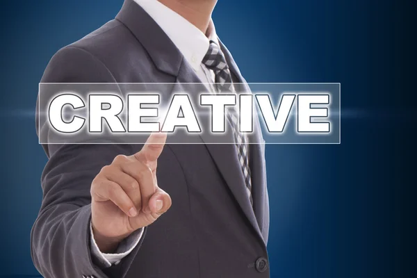 Businessman hand touching creative on screen — Stock Photo, Image
