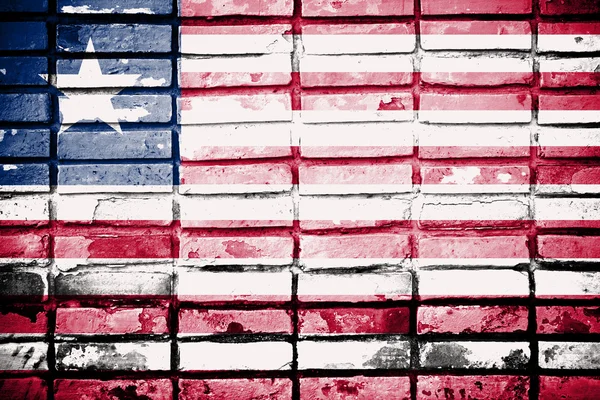 Liberia flag on old brick wall — Stock Photo, Image