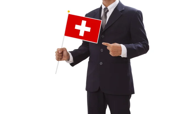Forretningsmann i dress under Sveits 'flagg – stockfoto