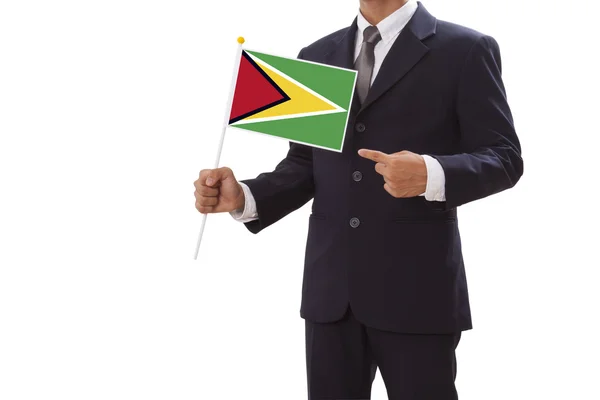 Affärsman i kostym innehav av Guyanas flagga — Stockfoto