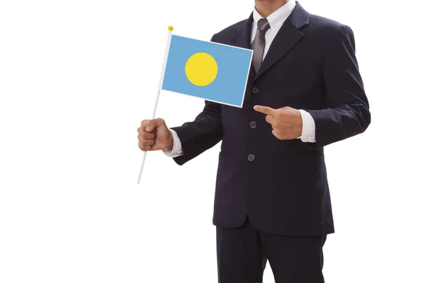 Businessman in suit holding of the Palau Flag — Stock Photo, Image