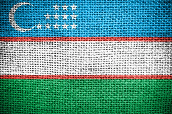 Bandera de Uzbekistán en la superficie de tela — Foto de Stock