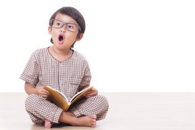 Sevimli çocuk gözlük takan bir kitap okuyor