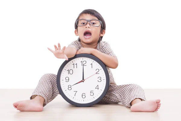 Cute boy is holding big clock — Stock Photo, Image