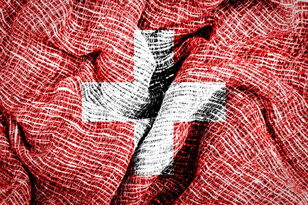 İsviçre bayrağı kumaş yüzeyinde — Stok fotoğraf